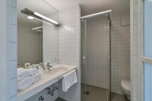 a bathroom with a sink and a shower at Luisenburg Resort in Wunsiedel