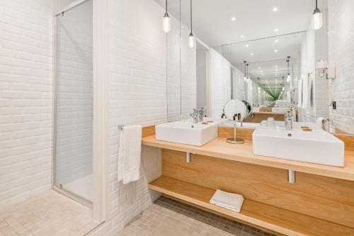 a bathroom with a sink and a shower at Globe Et Cecil in Lyon