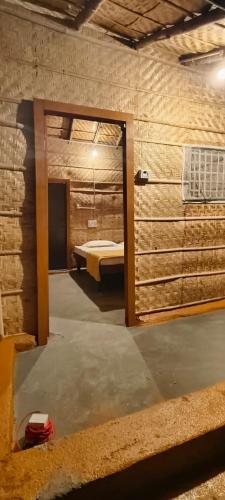 a room with a room with a bed in it at Banana Tree Home Stay in Hampi