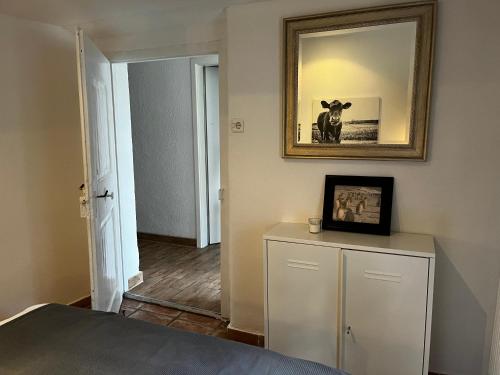 a bedroom with a bed and a mirror on the wall at Ferienwohnung Gartenglück in Traunstein