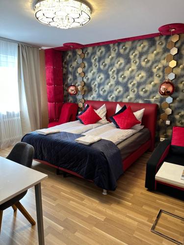 a bedroom with a large bed with red pillows at Diamanthaus deluxe 7 Koblenz in Koblenz