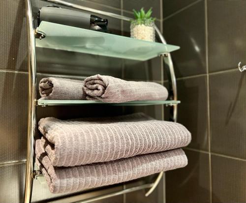 a bunch of towels on a towel rack in a bathroom at K22 Vip Centrum open-space Bagno in Warsaw