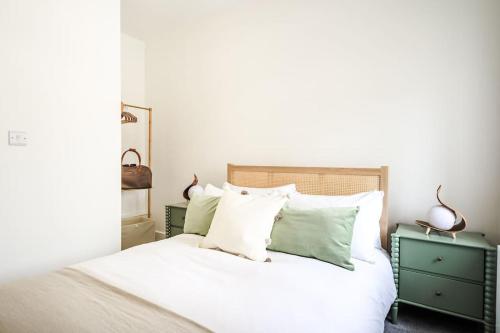 a bedroom with a bed with green and white pillows at Newport Ship's Nook: Cozy Hideaway in Newport