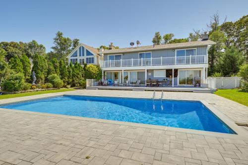 a home with a swimming pool in front of a house at Spacious Rocky Point Retreat with Al Fresco Dining! in Rocky Point