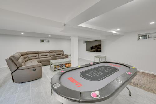 a living room with a ping pong table and a couch at Spacious Rocky Point Retreat with Al Fresco Dining! in Rocky Point