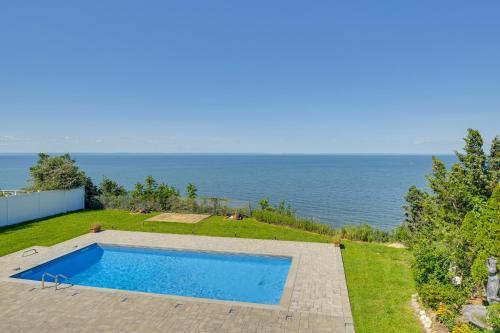a swimming pool on a hill next to the ocean at Spacious Rocky Point Retreat with Al Fresco Dining! in Rocky Point