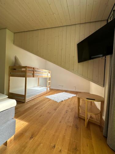 a room with bunk beds and a flat screen tv at Traumferienhaus Leimbach am Nürburgring in Leimbach