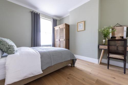a bedroom with a bed and a window at Charming Elegance at The Pontcanna Pearl - Prime Location with Comfort and Style in Cardiff