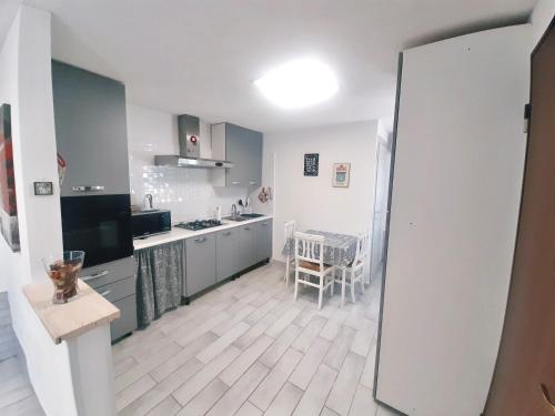 a kitchen with a table and a dining room at Coccinella house in Le Casette