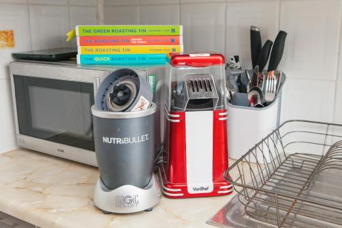 a kitchen counter with a blender and a microwave at Peaceful Oasis By The Sea in Edinburgh