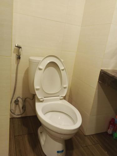 a bathroom with a toilet with the lid up at MESA Thamrin City Apartments at Nagoya with Netflix & Pick Up Service in Nagoya