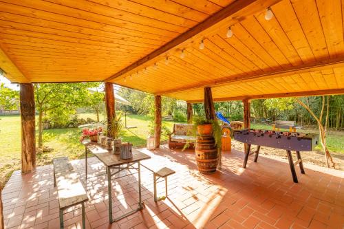 a covered patio with a table and a pool table at Casa Vacanze Mongili - Il Moro in Chiusi
