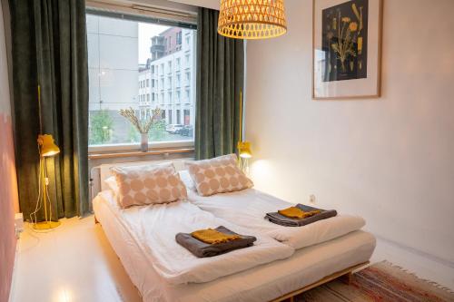 a white couch sitting in a room with a window at Arctic Circle Retreat: Stylish 2-Room Apartment in Rovaniemi