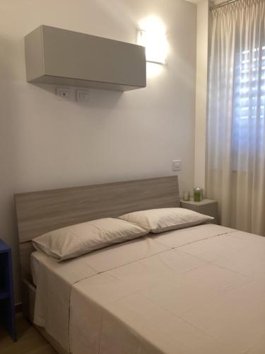 a bedroom with a large bed with a hood at Il mare a due passi in Civitanova Marche