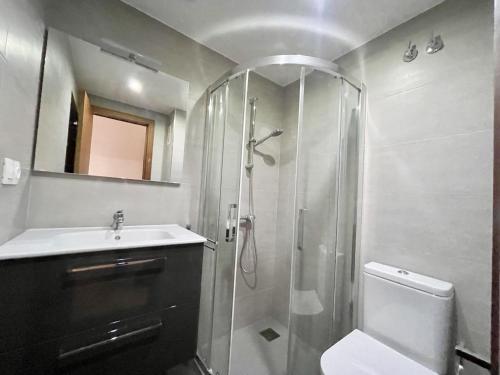 a bathroom with a shower and a toilet and a sink at Principado Wifi, Airco, Beach and Garden in Benidorm
