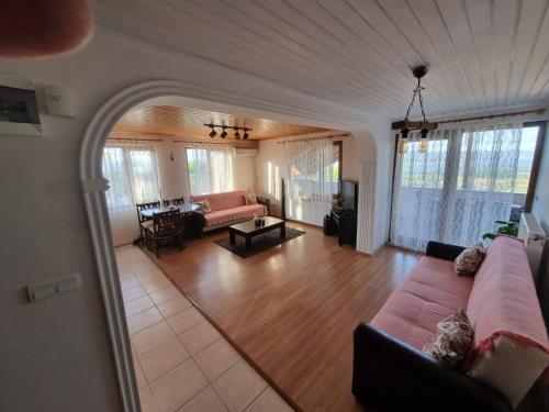 a living room with a couch and a table at SNOW HİLL HOUSE Pansiyon in Kartepe