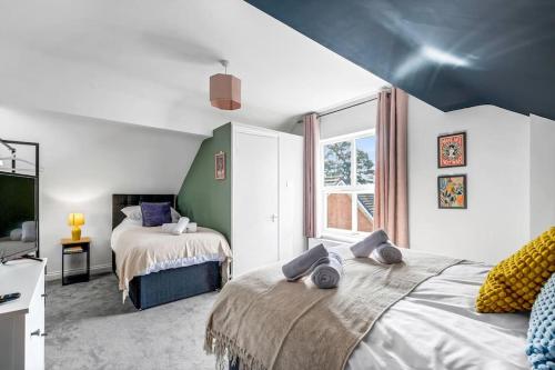 a bedroom with two beds and a large window at Redditch 4 Bed 3 Bath From 21 PP Per Night 5 Star in Redditch