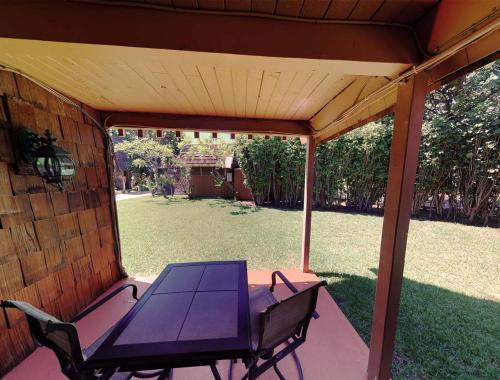 a patio with a table and chairs on a porch at Hotel Moloka'i in Kaunakakai