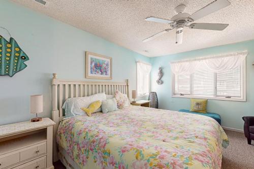 a bedroom with a bed and a ceiling fan at Villa Del Mar in Corolla