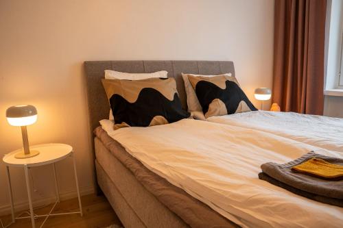 a bedroom with a large bed with pillows on it at Urban Arctic Elegance: 2-Room Stylish Getaway in Rovaniemi