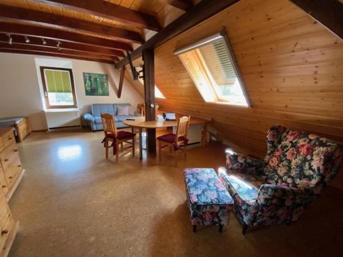 a living room with a couch and a table and chairs at Landhotel Garni Knittelsheimer Mühle in Knittelsheim