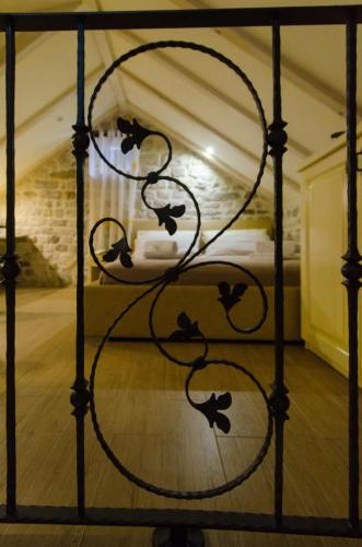 a metal bed frame with a bed in a room at Apartments Kaja in Trogir