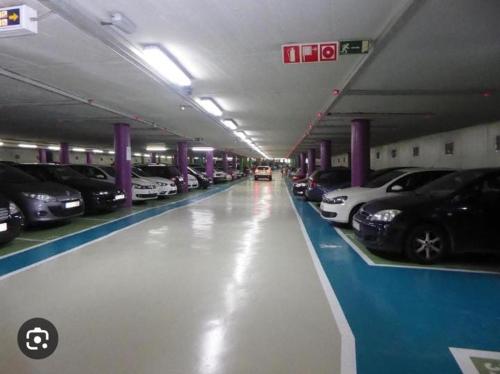 a parking garage filled with lots of parked cars at Pension Suiza in Reus