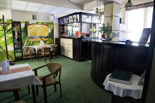 a restaurant with a bar and some tables and chairs at Hotel i Restauracja Nad Jeziorem in Człuchów