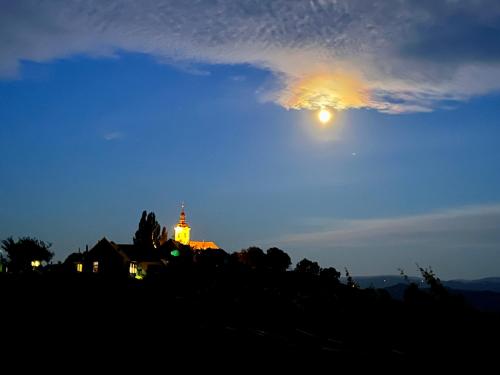 a church on top of a hill at night at Ferienhaus Sausalblick in Großklein