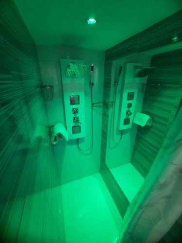 an empty bathroom with green lights in a room at MY & DI in Rome