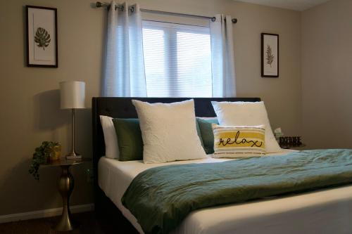 a bedroom with a bed with pillows and a window at Cloud's Bnb - The Signature Suite, for cooks. in Elizabethtown