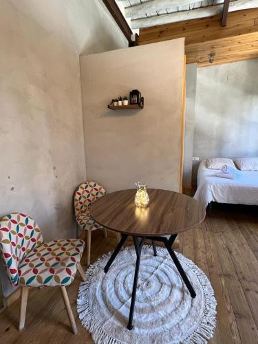 Zimmer mit einem Tisch, 2 Stühlen und einem Bett in der Unterkunft Suite Catedral in Granada