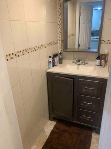 a bathroom with a sink and a mirror at Studio by New York Harbor in Saint George