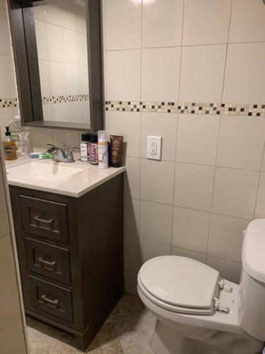 a bathroom with a toilet and a sink at Studio by New York Harbor in Saint George