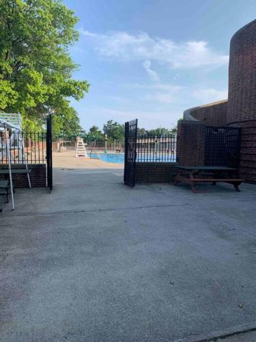 a gate in a park with a playground at Studio by New York Harbor in Saint George