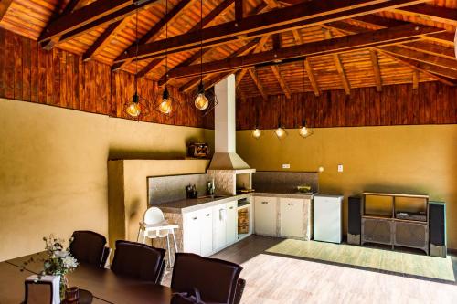 a kitchen with a table and chairs in a room at Forest Oasis Guest House FREE PARKING in Sapareva Banya