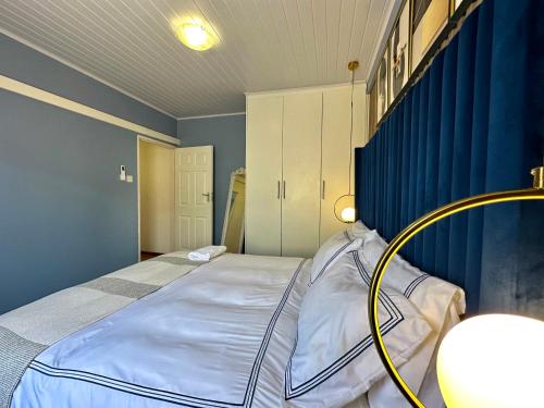 a bedroom with a large bed with a yellow hose at Exquisite short and long stay in Gaborone