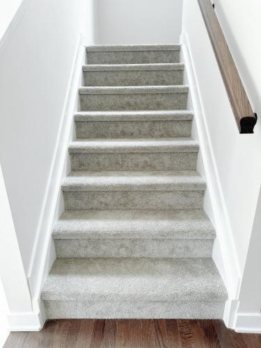 a staircase in a house with a grey carpet at Private bedroom in Stittsville