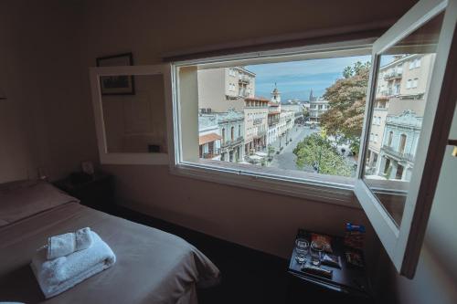 una camera da letto con finestra affacciata sulla città di Hotel Colonial Salta a Salta