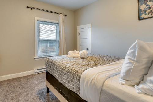 a bedroom with a bed with a towel on it at Spokane Vacation Rental with Central Location! in Spokane