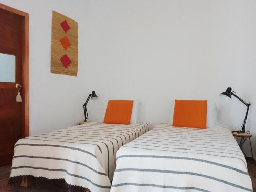 two beds sitting next to each other in a room at Casita de Piedra in Bogotá