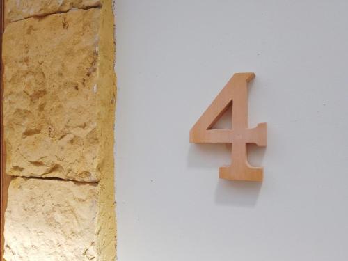a number four sign on the side of a wall at Casita de Piedra in Bogotá