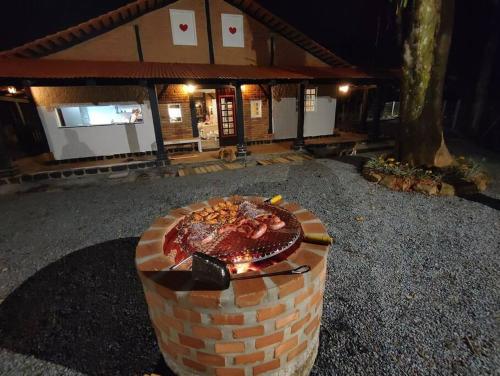 a brick oven with a cake on top of it at Casa Enxaimel 02 em Pomerode in Pomerode
