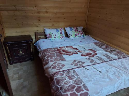 a bedroom with a bed with a giraffe blanket at Villa Te Ibra - Rugovë in Peje