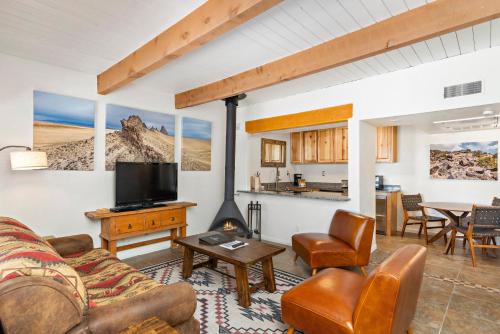 a living room with a couch and a fireplace at Fort Marcy Suites by All Seasons Resort Lodging in Santa Fe