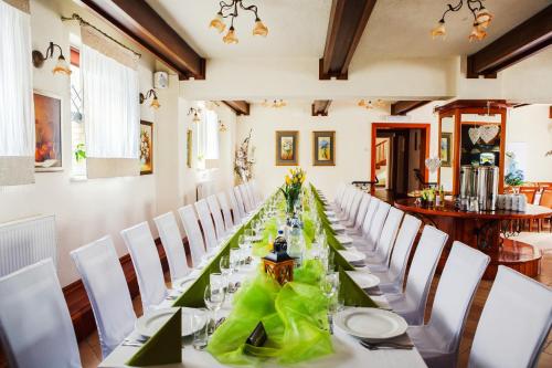 a long table in a room with white chairs at Hotel i Restauracja Nad Jeziorem in Człuchów