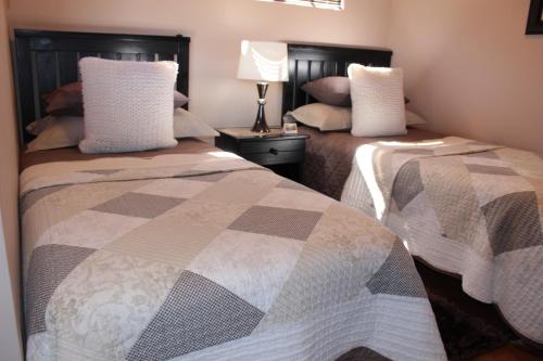 a bedroom with two beds with pillows on them at Valley Bushveld Country Lodge in Addo