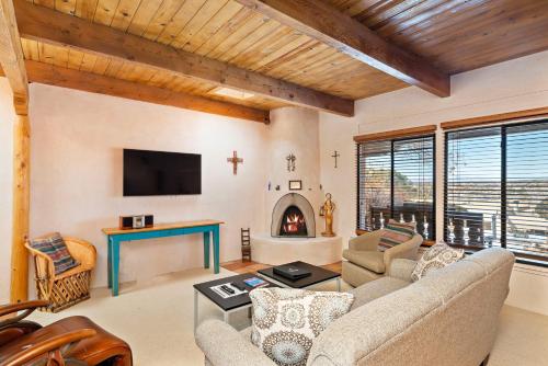 a living room with a couch and a fireplace at Fort Marcy Suites by All Seasons Resort Lodging in Santa Fe