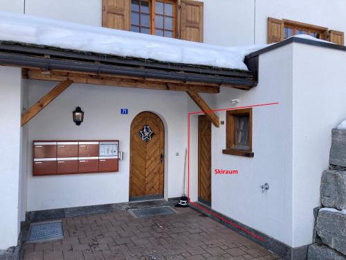a house with a door and a snow covered roof at Guardaval in Arosa
