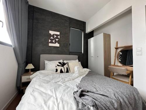 a bedroom with a large bed with a black wall at Best for Family KLCC Pavillion Sunway Velocity MRT in Kuala Lumpur